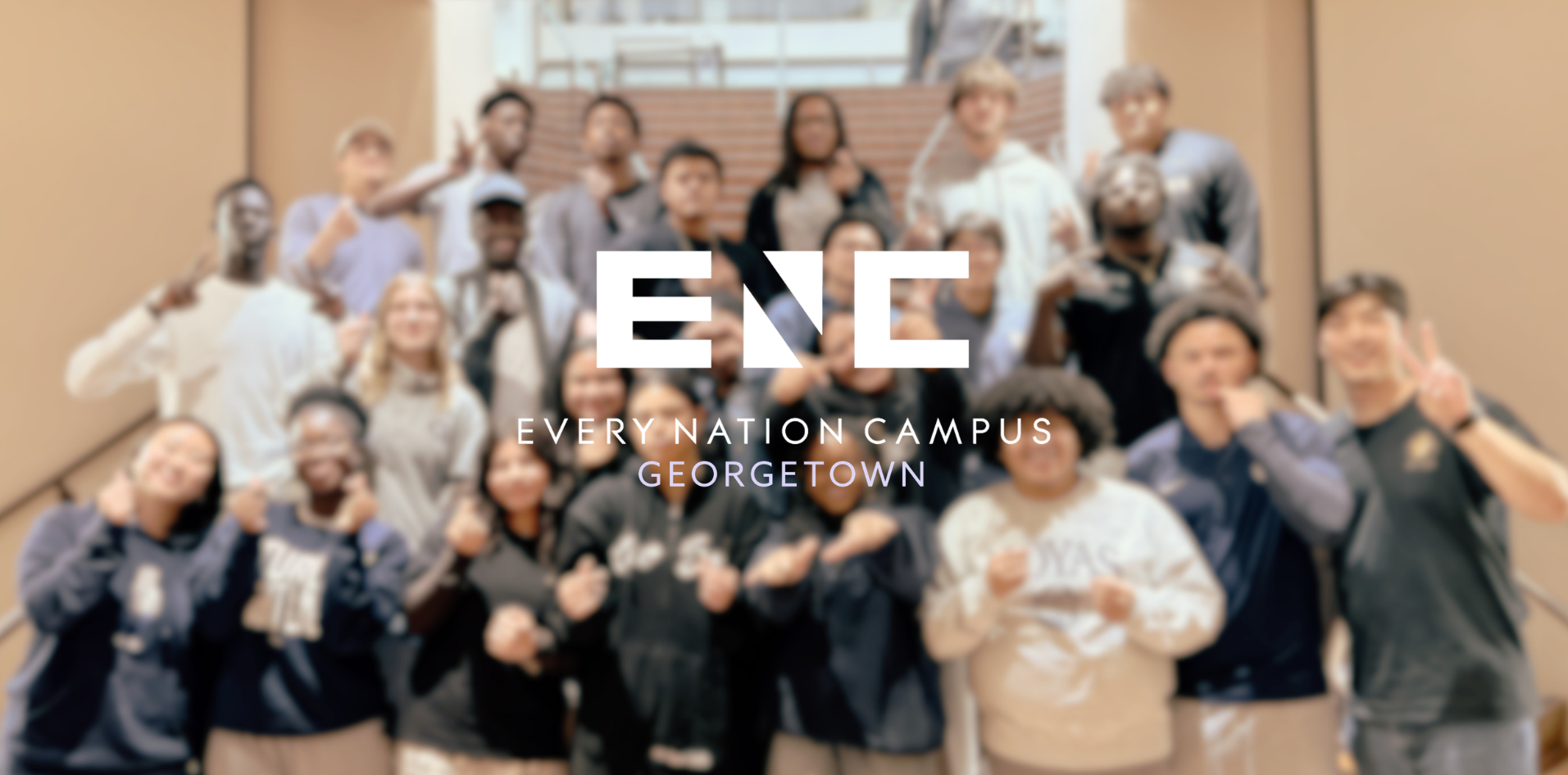 Every Nation Campus Georgetown logo over a photo of students on a staircase